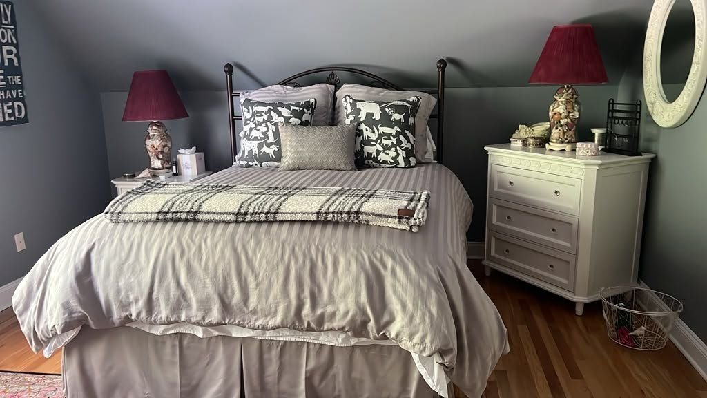 A freshly made bed in a guest bedroom