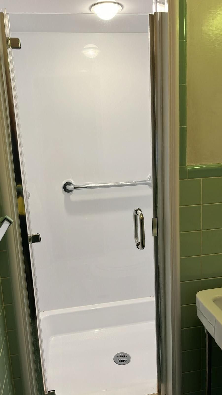 A spotless white shower stall after a detailed cleaning
