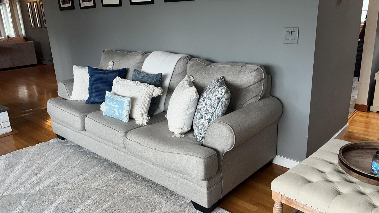 A clean, tidy living room with a sofa and throw pillows